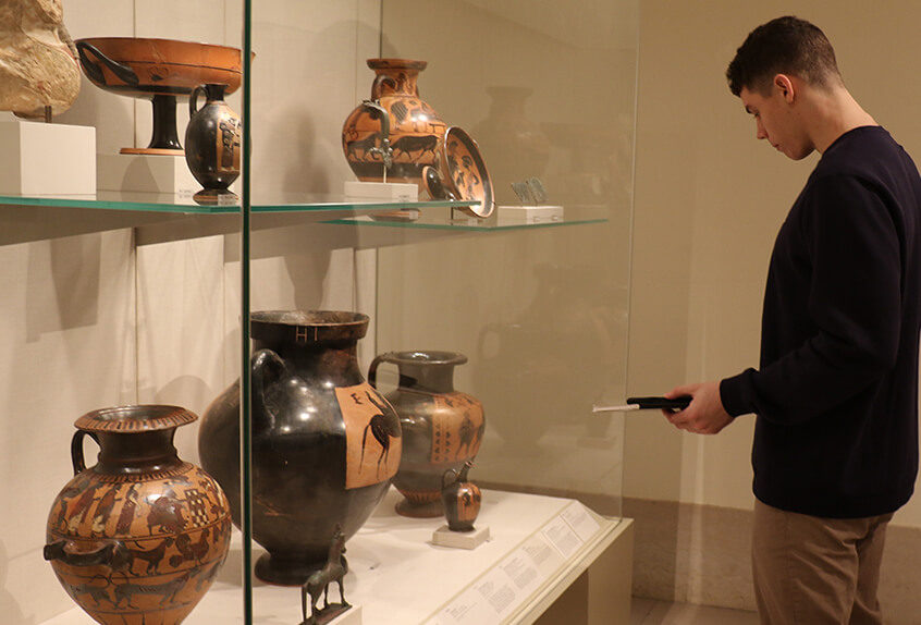 US AP History at MET for Art of Native American exhibit student looks at pottery