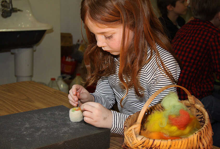 Lower school student learning about fiber arts