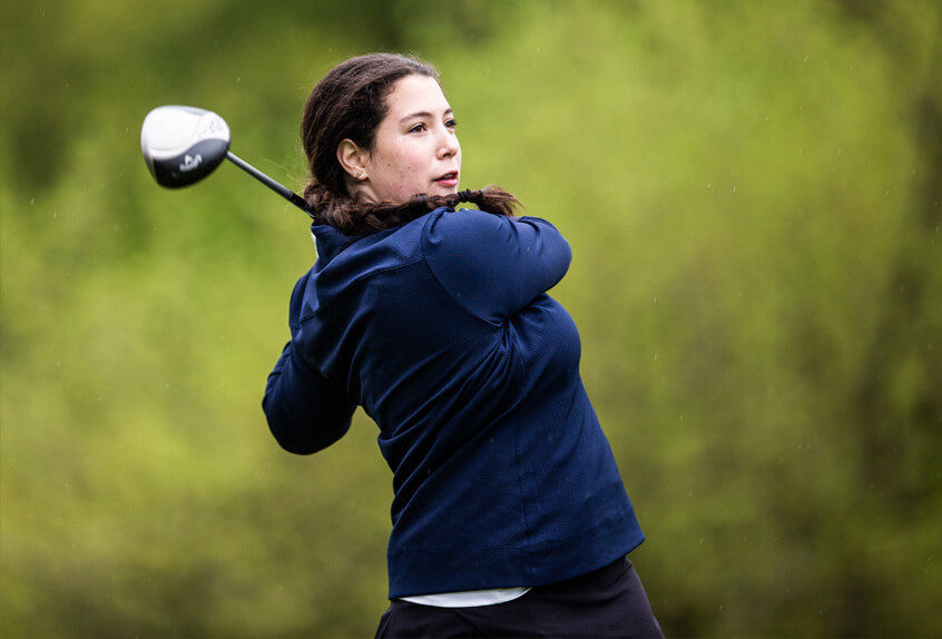 Poly Prep Golf team Athlete swings the golf club