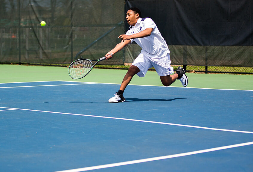 Boys Tennis player hitting the tennis ball