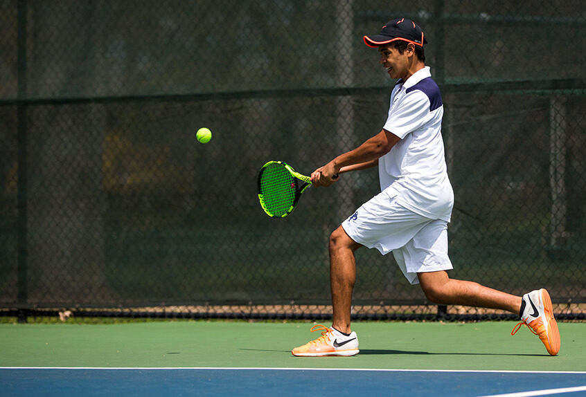 Boys Tennis player hitting the tennis ball