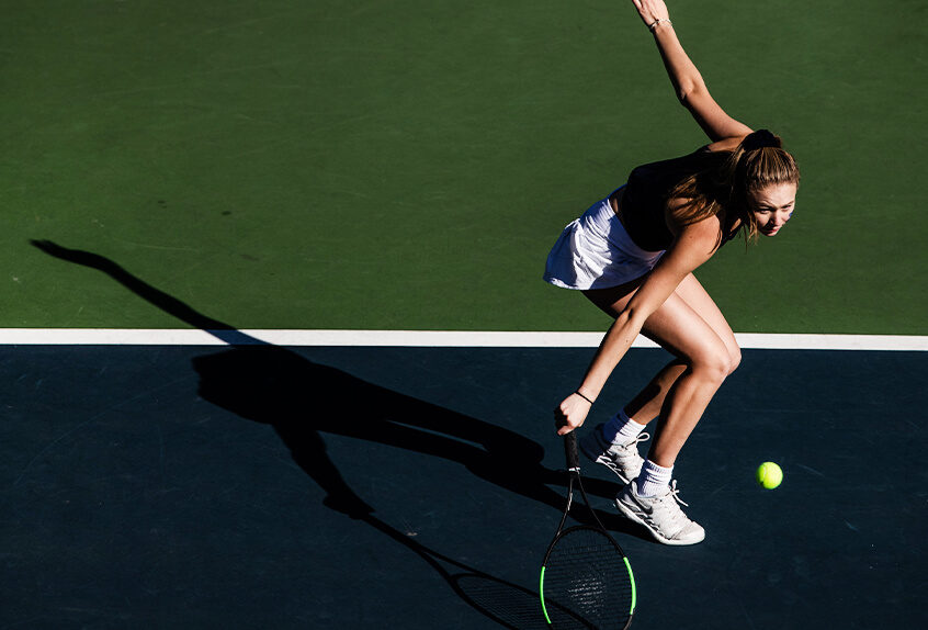 Girls Tennis player hitting the tennis ball