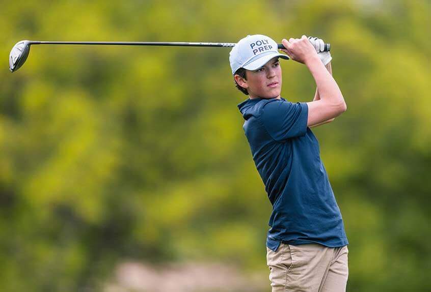 Student golfer taking a swing