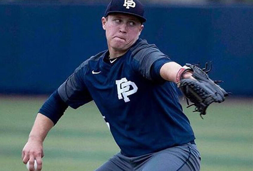 Poly Prep pitcher wound up to throw the pitch