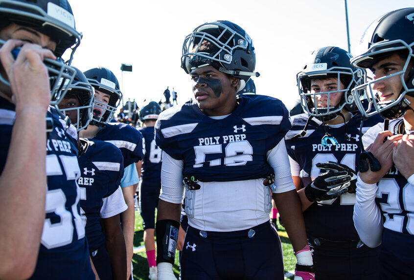 Poly Prep Varsity Football team in a huddle