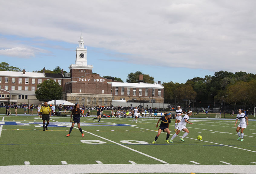 Poly Varsity Girls Soccer team playing on the main field