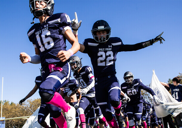 Poly Prep Homecoming Football players running to the field