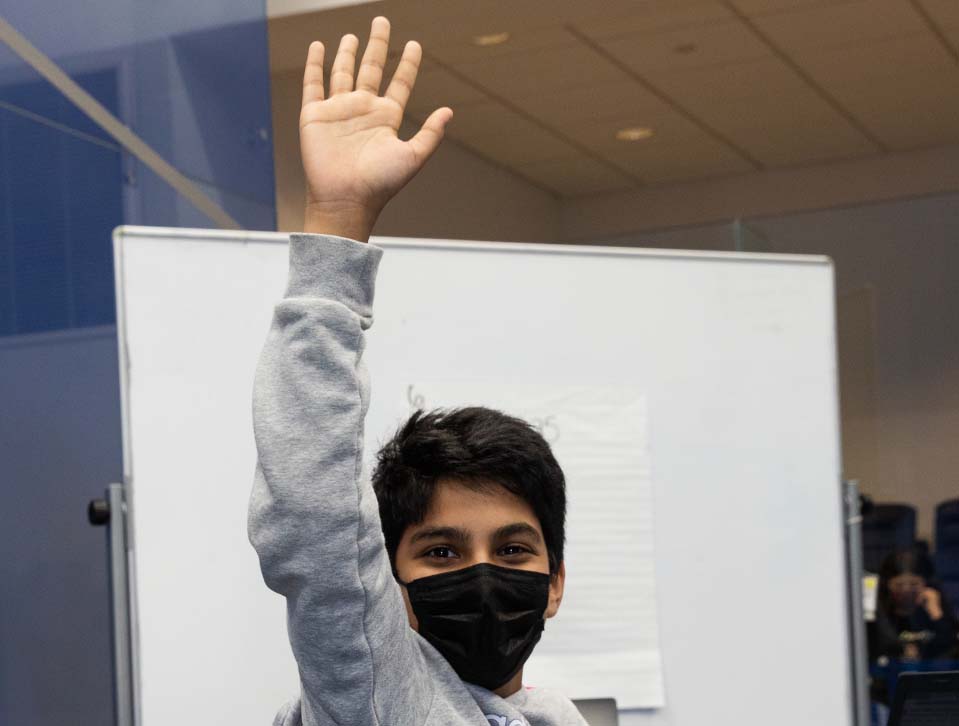 Masked Student raising hand