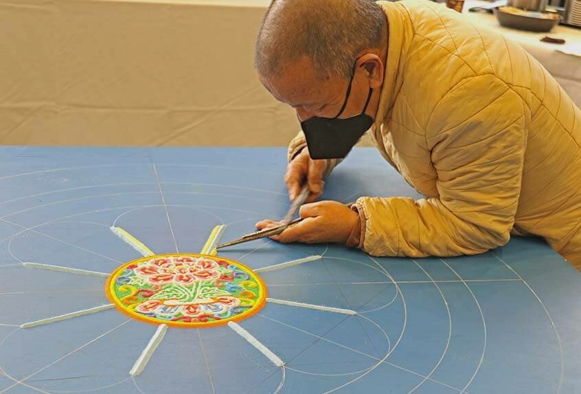 Lama Tenzin works on mandala