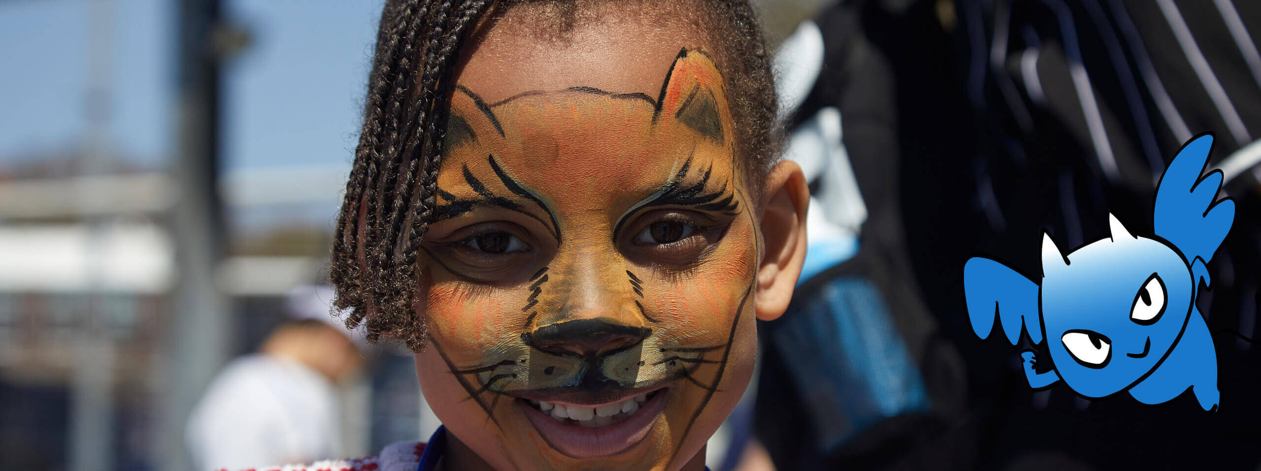 Face painted child with Blue Devil sidekick