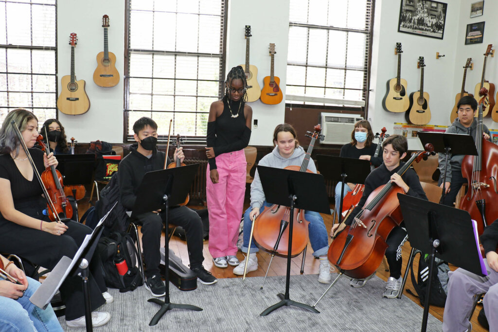 Jordan Millar listens as fellow students rehearse her string composition.