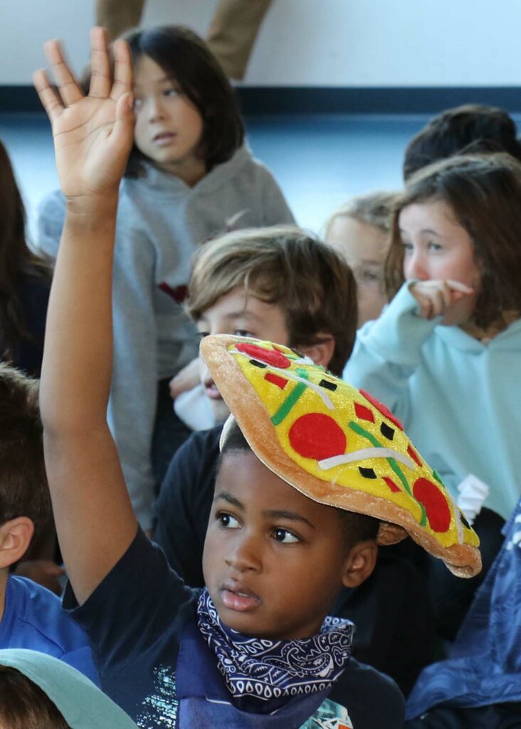 Student with pizza hat
