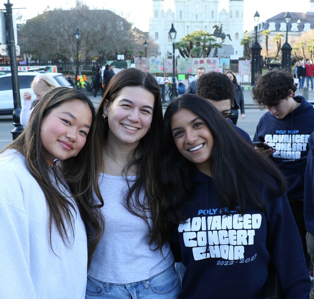 Poly Prep alumnae Francesca Corsalini ’22, Miranda Meyer ’22, and Anjali Budhram '24 of Advanced Concert Choir in front of Jackson Square, New Orleans 2023