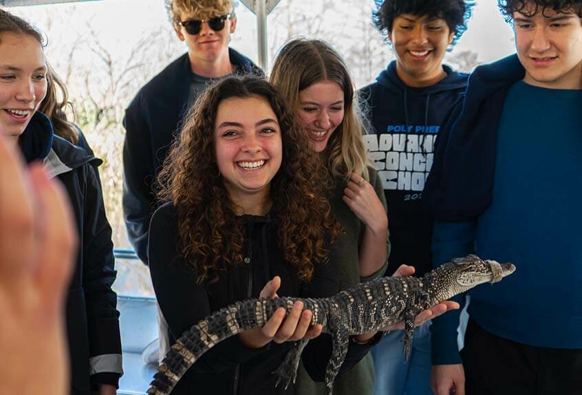 Advanced Concert Choir meets an alligator during swamp tour