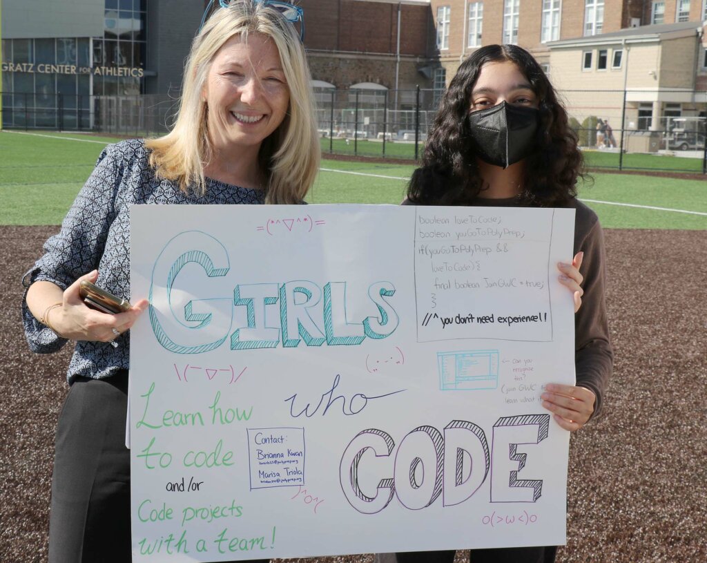 Jean Belford and Marisa Triola holding Girls Who Code sign