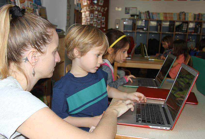 Lower School After School coding - teacher with student