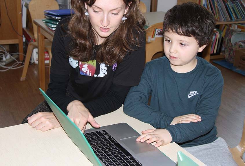 Lower School After School play - child, teacher with computer