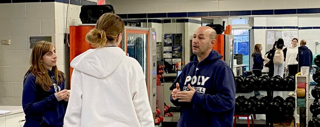 Athletic Trainera Alyssa Alaimo and John Pomponio talk to student