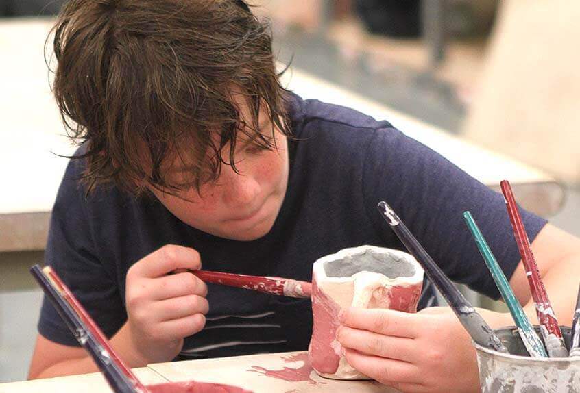 Boy doing ceramics at Poly Summer day camp