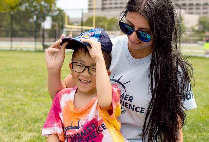 Smiling counselor with kid at Poly Summer day camp