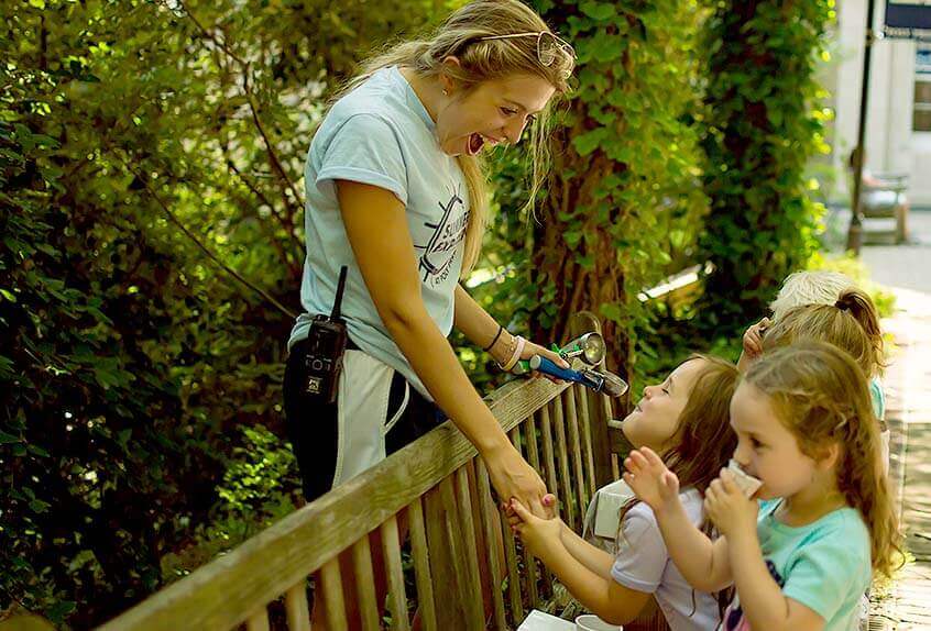 Smiling counselor with kids at Poly Summer day camp