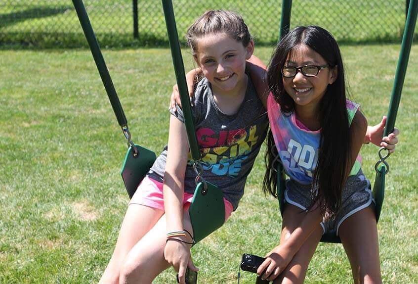 Friends on swings at Poly Summer day camp