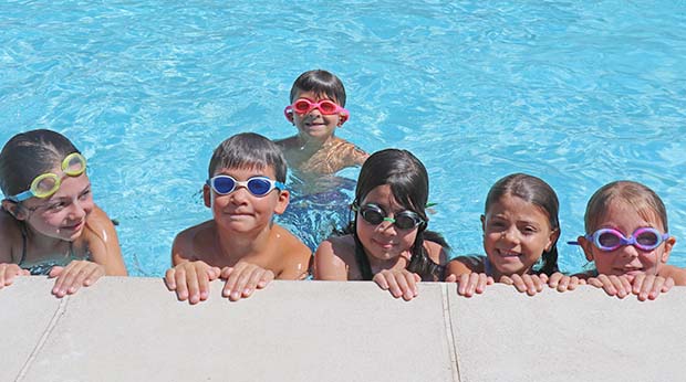 Kids smiling in the pool at Poly Summer camp