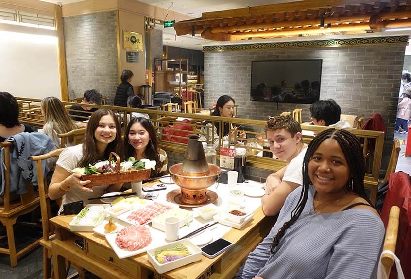 Students enjoy a meal at a hot pot restaurant in Beijing (Mackenzie Grant-Hinckson '28, Lila, Kara Shum '28, and Quinn Foley M'26)