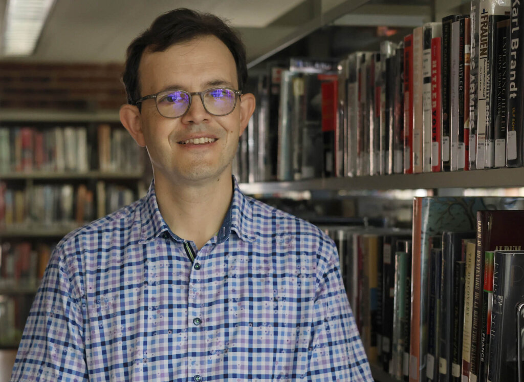 James Ogilvie amongst the library books