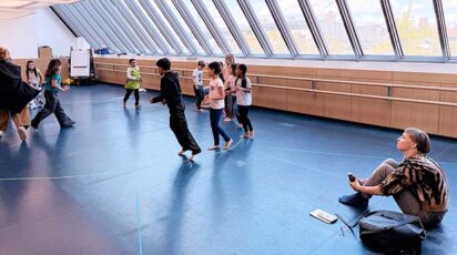 Lina Lapelytė watches Lower School students rehearse.
