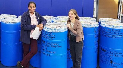 Shirley Dayes with Sarah Ely and barrels of donations for Jamaica.