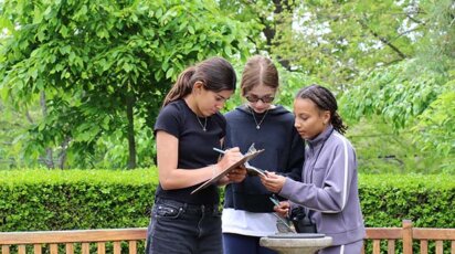 Middle School students studying ecosystems outdoors.